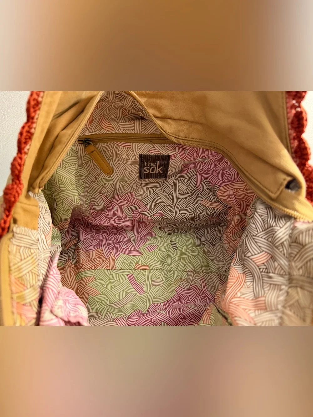The Sak tan canvas Indio hobo bag with braided brown straps and crochet trim
